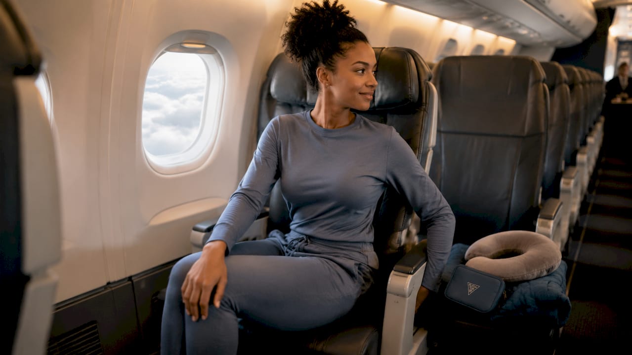 Woman practicing seated yoga stretch on airplane